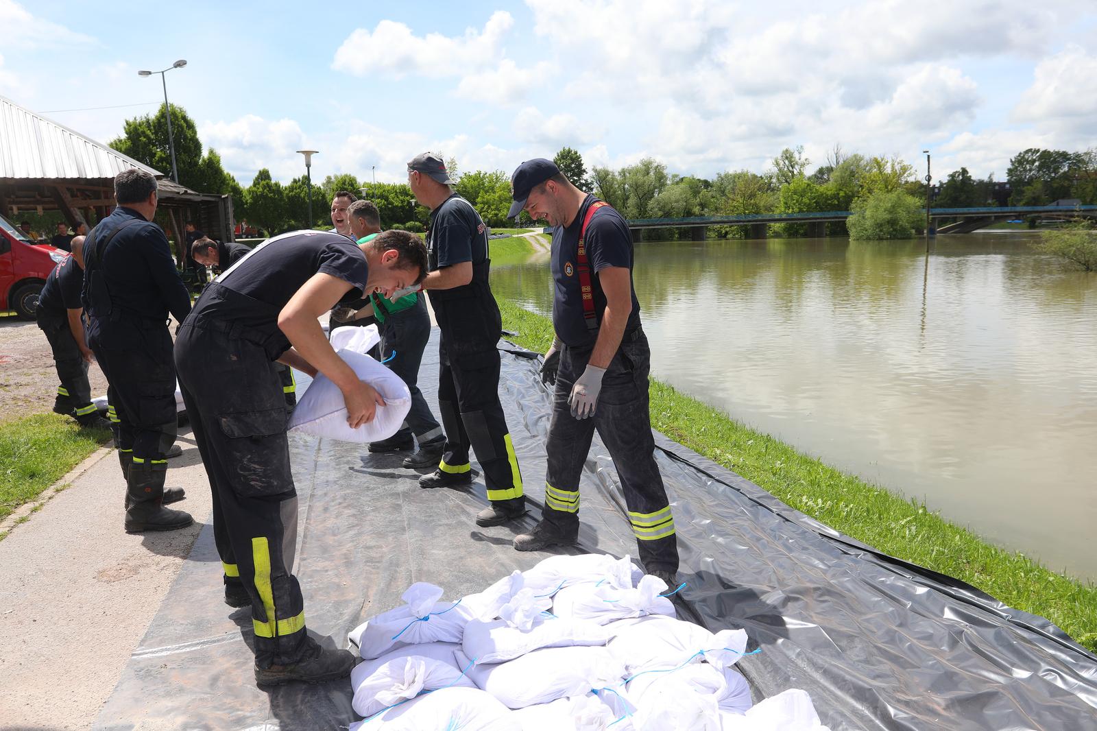 15.05.2023., Karlovac - Zbog porasta vodostaja rijeke Korane i najave novih oborina  vatrogasci JVP Karlovac i Vatrogasne zajednice grada Karlovca postavljaju zecji nasip uz rijeku Koranu na SRC-u Korana u duzini 200 metara. Photo: Kristina Stedul Fabac/PIXSELL