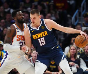 May 1, 2023; Denver, Colorado, USA; Denver Nuggets center Nikola Jokic (15) drives at Phoenix Suns center Deandre Ayton (22) in the first quarter during game two of the 2023 NBA playoffs at Ball Arena. Mandatory Credit: Ron Chenoy-USA TODAY Sports Photo: Ron Chenoy/REUTERS