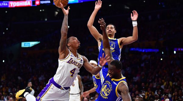 May 6, 2023; Los Angeles, California, USA; Los Angeles Lakers guard Lonnie Walker IV (4) shoots against Golden State Warriors guard Jordan Poole (3) and forward Draymond Green (23) during the first half in game three of the 2023 NBA playoffs at Crypto.com Arena. Mandatory Credit: Gary A. Vasquez-USA TODAY Sports Photo: Gary A. Vasquez/REUTERS