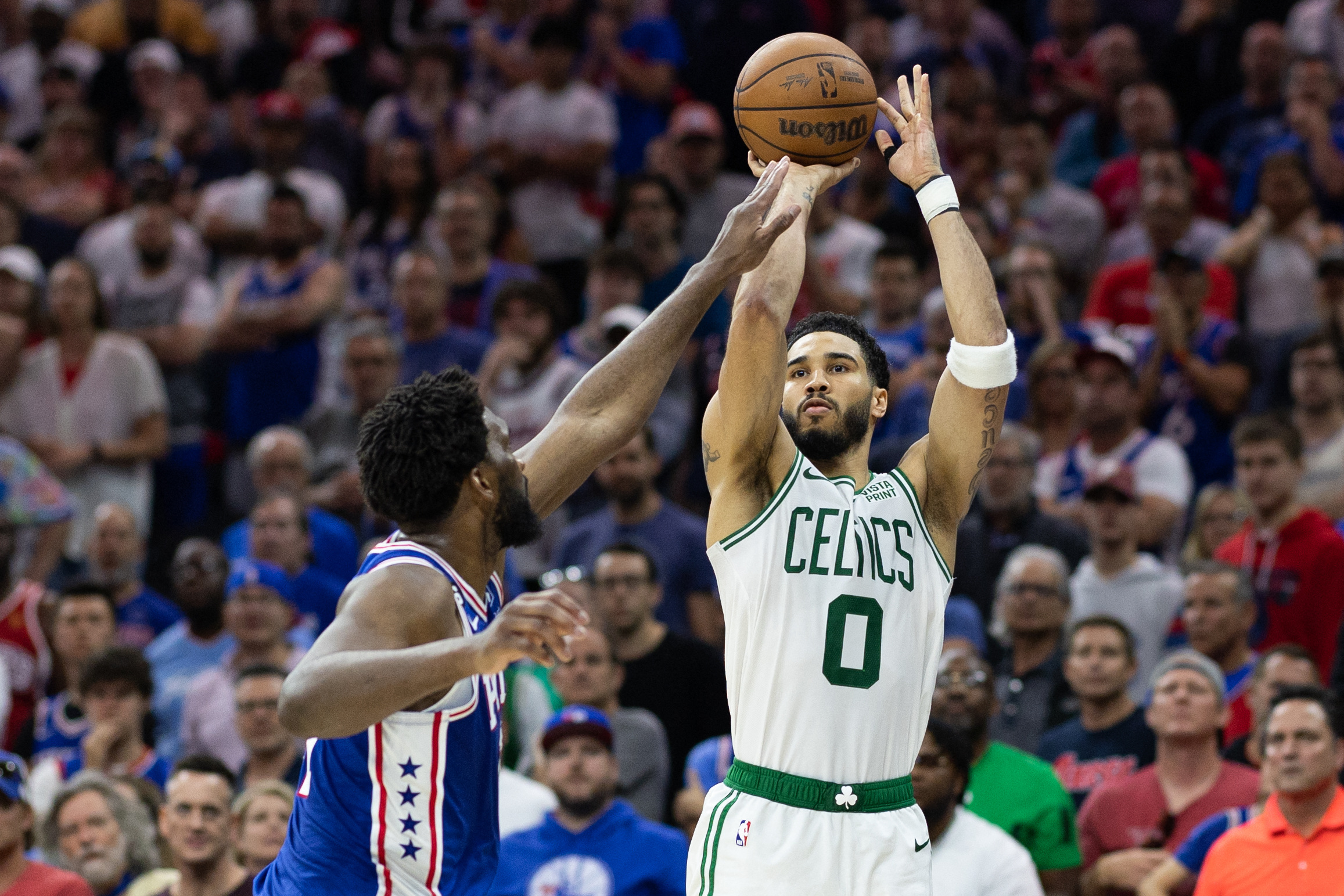 May 11, 2023; Philadelphia, Pennsylvania, USA; Boston Celtics forward Jayson Tatum (0) shoots the ball past Philadelphia 76ers center Joel Embiid (21) during the fourth quarter in game six of the 2023 NBA playoffs at Wells Fargo Center. Mandatory Credit: Bill Streicher-USA TODAY Sports Photo: Bill Streicher/REUTERS