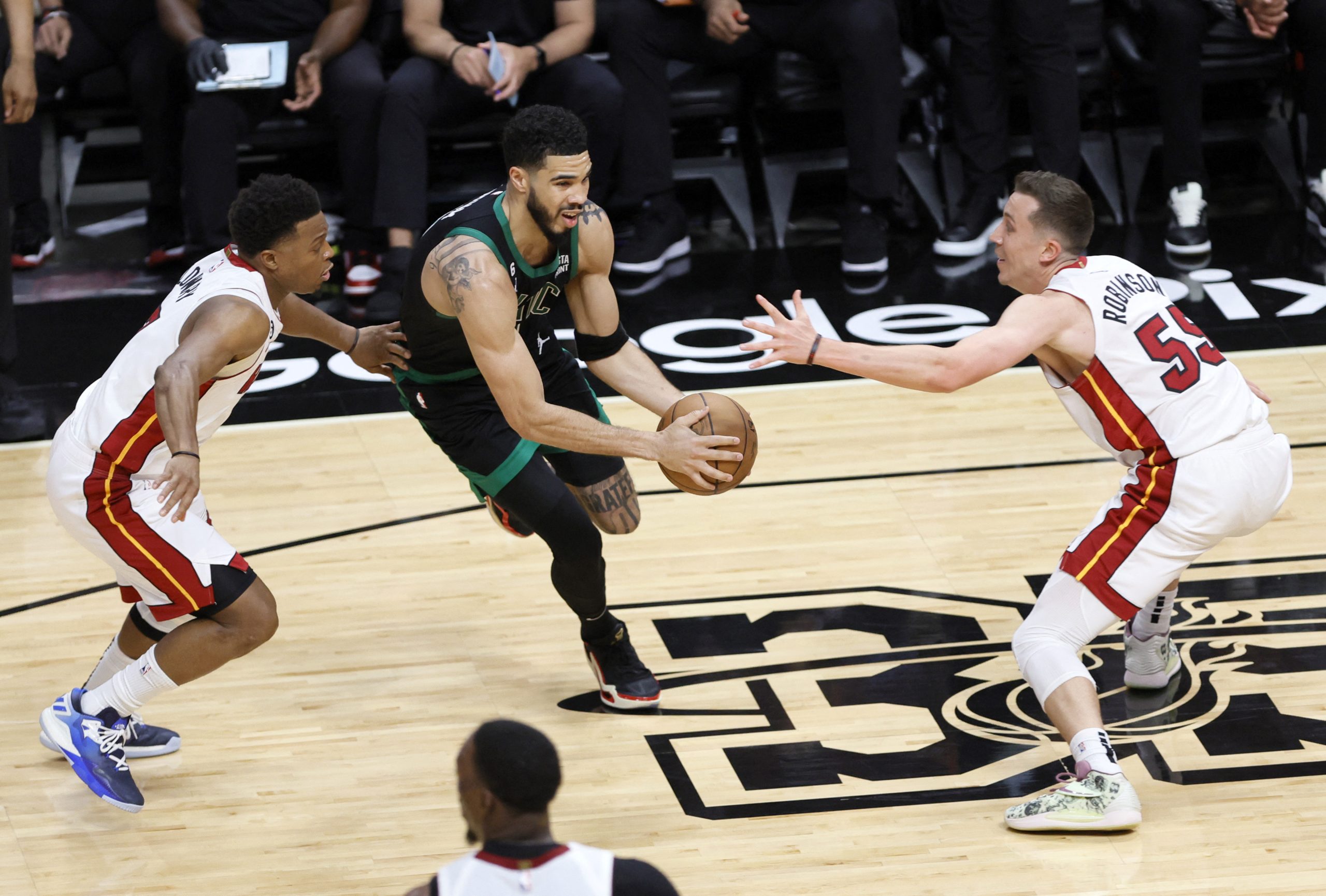 May 21, 2023; Miami, Florida, USA; Boston Celtics forward Jayson Tatum (0) dribbles against Miami Heat guard Kyle Lowry (7) and forward Duncan Robinson (55) during the first half in game three of the Eastern Conference Finals for the 2023 NBA playoffs at Kaseya Center. Mandatory Credit: Sam Navarro-USA TODAY Sports Photo: Sam Navarro/REUTERS