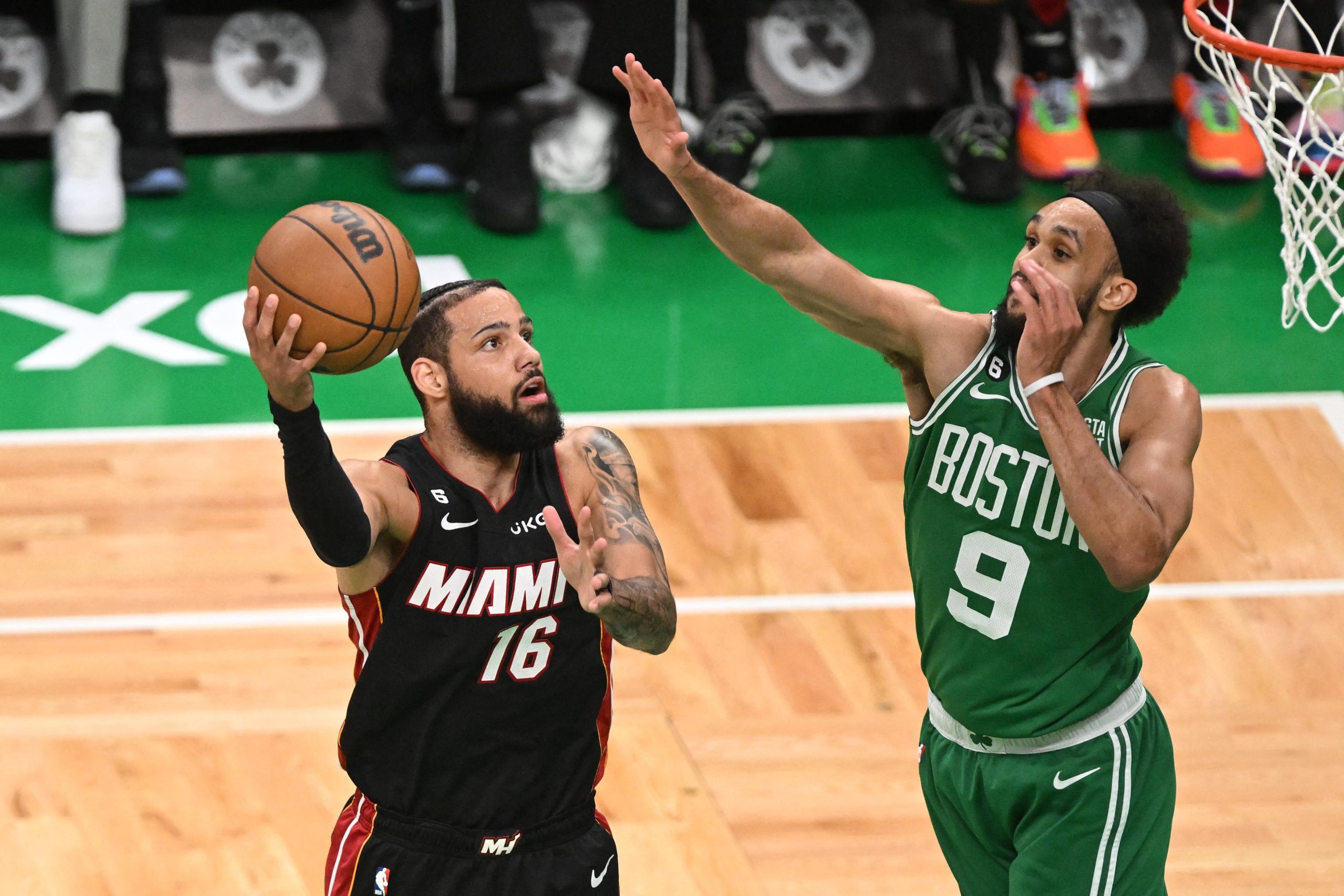 May 25, 2023; Boston, Massachusetts, USA; Miami Heat forward Caleb Martin (16) shoots against Boston Celtics guard Derrick White (9) in the first quarter during game five of the Eastern Conference Finals for the 2023 NBA playoffs at TD Garden. Mandatory Credit: Brian Fluharty-USA TODAY Sports Photo: Brian Fluharty/REUTERS