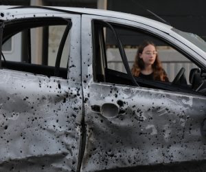 epa10604548 A child looks at a damaged car at the site where a rocket landed outside a house in the southern city of Sderot, Israel, 02 May 2023. Militant groups in Gaza claimed responsibility for firing dozens of rockets from the Gaza Strip toward southern Israeli cities after Palestinian prisoner Khader Adnan's death was announced. The Palestinian Prisoners Club confirmed that Adnan died on 02 May 2023 in an Israeli prison following more than 85 days of hunger strike, refusing administrative detention.  EPA/ABIR SULTAN