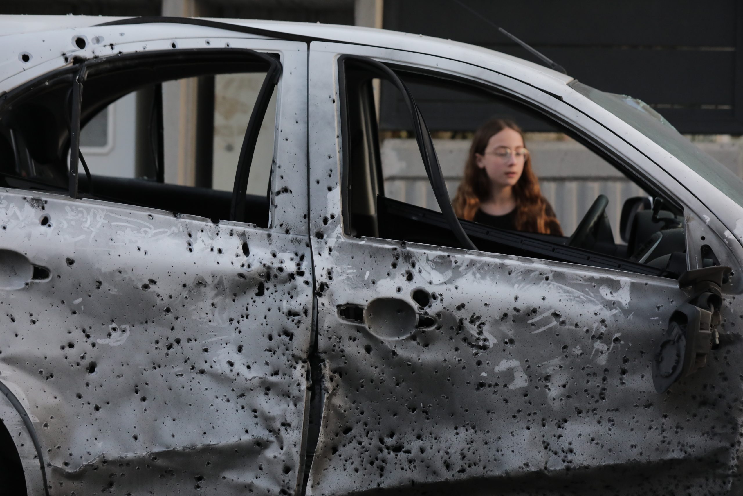epa10604548 A child looks at a damaged car at the site where a rocket landed outside a house in the southern city of Sderot, Israel, 02 May 2023. Militant groups in Gaza claimed responsibility for firing dozens of rockets from the Gaza Strip toward southern Israeli cities after Palestinian prisoner Khader Adnan's death was announced. The Palestinian Prisoners Club confirmed that Adnan died on 02 May 2023 in an Israeli prison following more than 85 days of hunger strike, refusing administrative detention.  EPA/ABIR SULTAN
