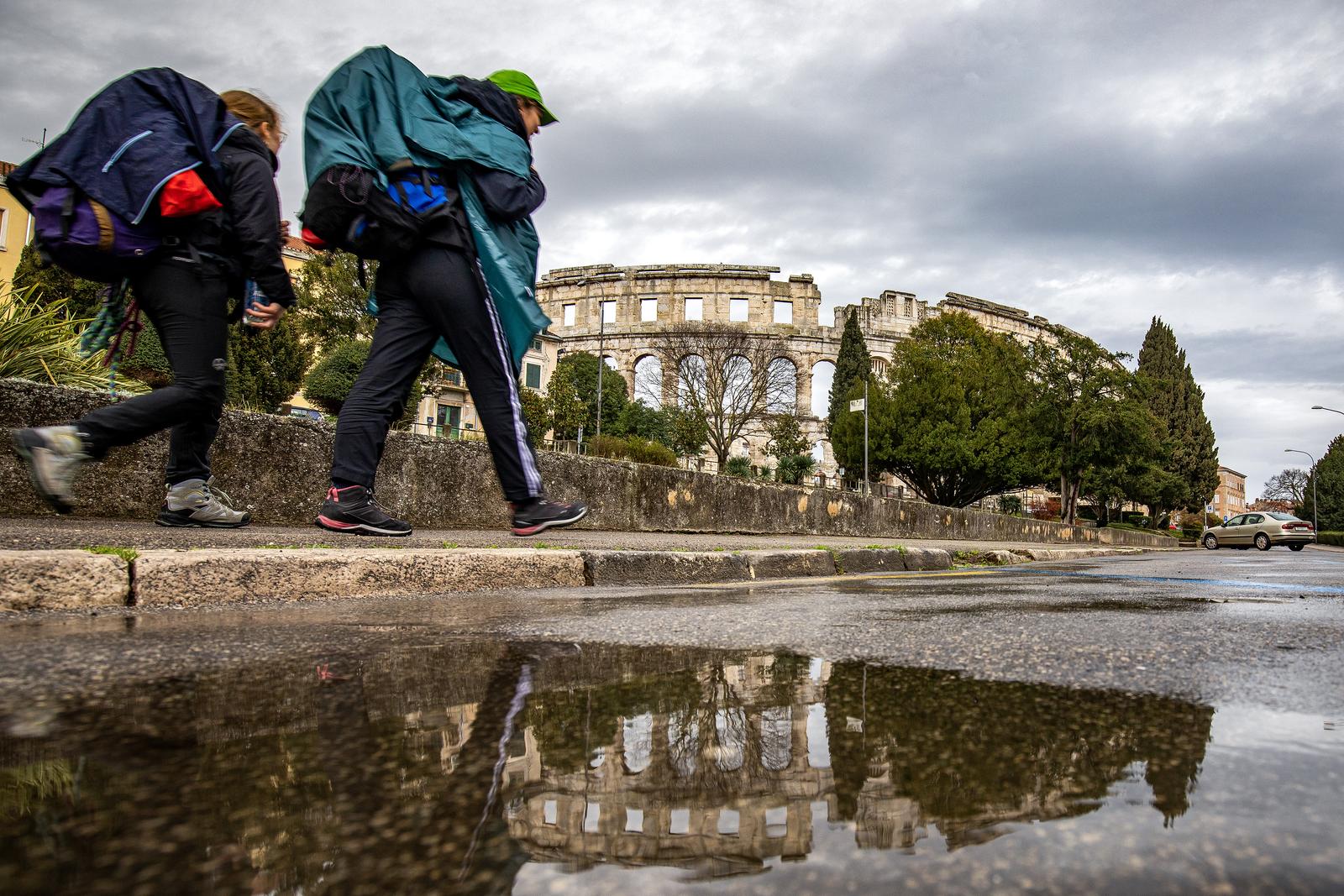 14.03.2023., Pula - Refleksije Arene u lokvicama nakon kise. Photo: Srecko Niketic/PIXSELL