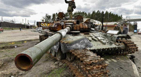 epa09884456 A man stands on destroyed russian tanks in Buzova village of Kyiv (Kiev) area, Ukraine, 11 April 2022.  On 24 February, Russian troops had entered Ukrainian territory in what the Russian president declared a 'special military operation', resulting in fighting and destruction in the country, a huge flow of refugees, and multiple sanctions against Russia.  EPA-EFE/OLEG PETRASYUK