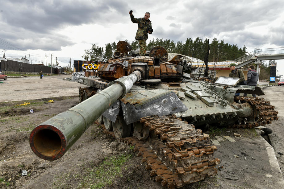 epa09884456 A man stands on destroyed russian tanks in Buzova village of Kyiv (Kiev) area, Ukraine, 11 April 2022.  On 24 February, Russian troops had entered Ukrainian territory in what the Russian president declared a 'special military operation', resulting in fighting and destruction in the country, a huge flow of refugees, and multiple sanctions against Russia.  EPA-EFE/OLEG PETRASYUK