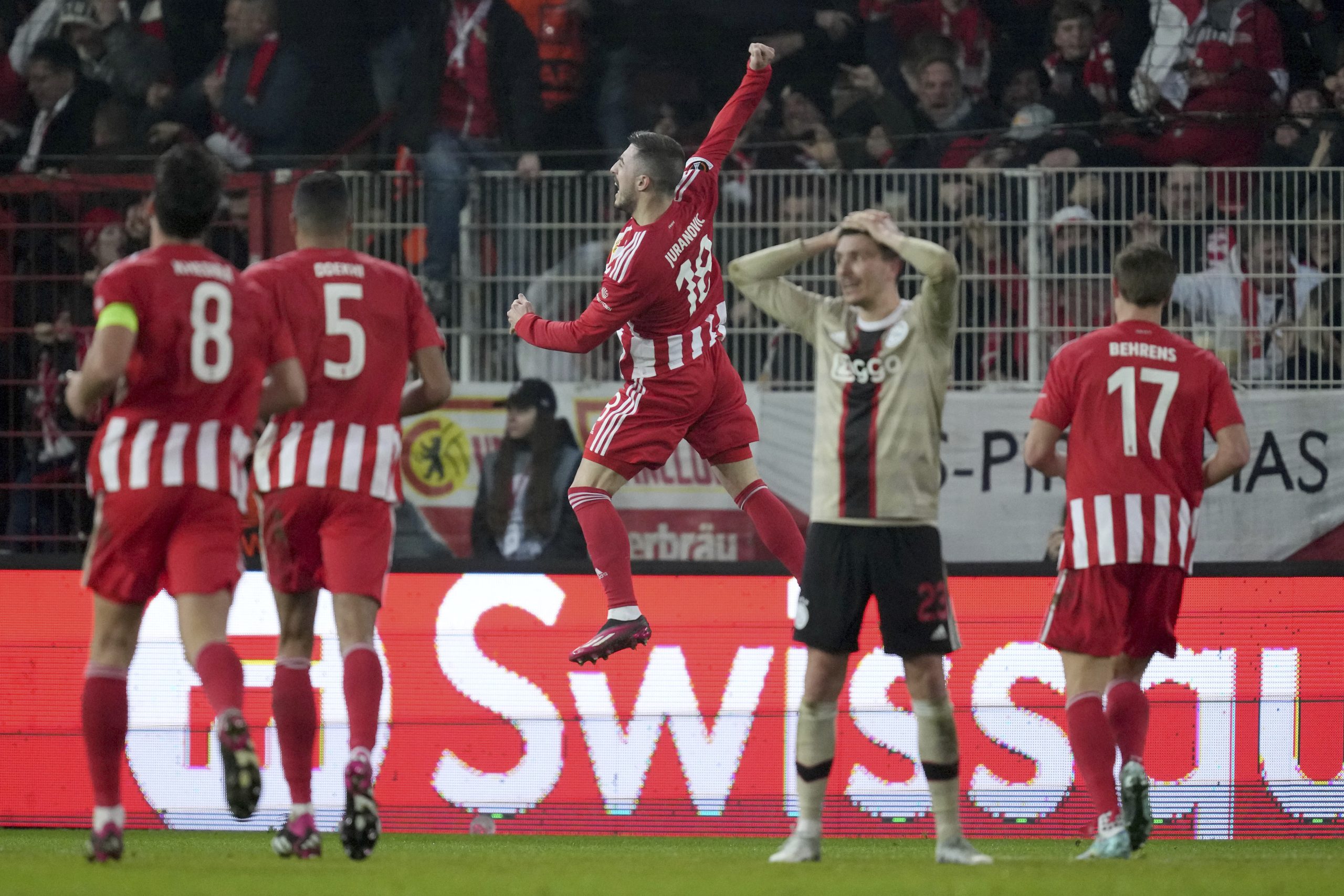 Union's Josip Juranovic, center, celebrates after scoring his side's second goal during the Europa League playoff second leg soccer match between 1. FC Union Berlin and Ajax Amsterdam in Berlin, Germany, Thursday, Feb. 23, 2023. (AP Photo/Michael Sohn)