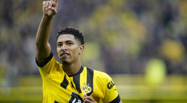 FILE - Dortmund's Jude Bellingham celebrates after scoring during the German Bundesliga soccer match between Borussia Dortmund and Eintracht Frankfurt in Dortmund, Germany, Saturday, April 22, 2023. Real Madrid has confirmed the signing of England midfielder Jude Bellingham from Borussia Dortmund. The Spanish club described Bellingham as one of the “biggest talents in world football.” Bellingham is 19 and has already established himself among the most sought-after players in soccer. Manchester United, Man City, Liverpool and Paris Saint-Germain were among his admirers. (AP Photo/Martin Meissner, File)