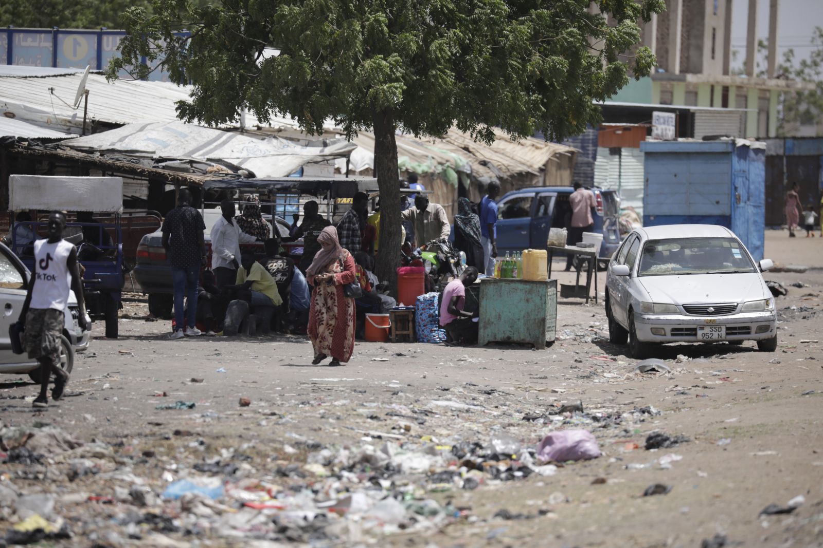 epa10625670 People who fled the conflict in Sudan gather with their belongings under the shade of a tree in the Upper Nile State town of Renk, South Sudan, 13 May 2023. According to UNHCR, at least 40,000 people have arrived into South Sudan since armed clashes between Sudan's military and rival paramilitary groups began in Khartoum and other parts of the country on 15 April 2023. Most of the refugees are part of the some 800,000 South Sudanese who had previously fled the war in South Sudan and who are now returning to a country with tensions still remaining in many areas, and more than two million internally displaced people. Upon arriving at the Joda border crossing, the refugees head to a transit area set up by UNHCR in the small town of Renk, where various UN agencies assist them with registration, food, health check and logistics.  EPA/AMEL PAIN