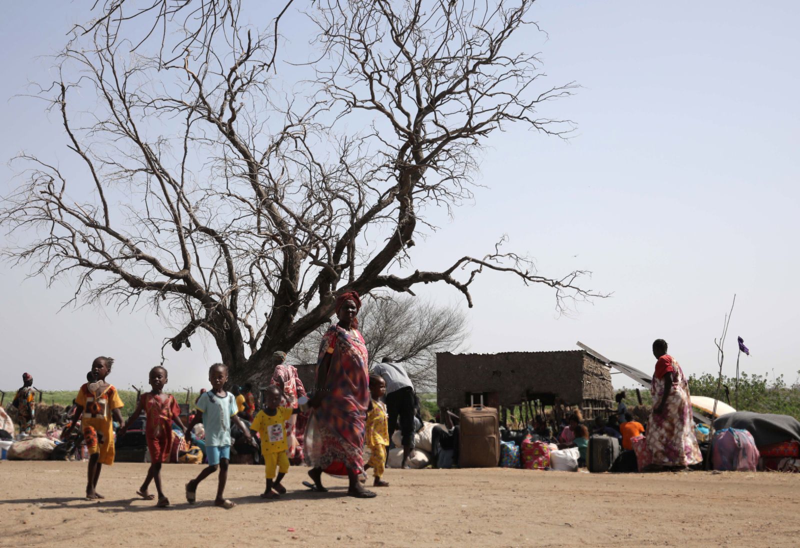 epa10628534 South Sudanese returnees who fled the ongoing conflict in Sudan, gather in the vicinity of the fluvial port of Renk as they wait to be transported south, in the Upper Nile State town of Renk, South Sudan, 14 May 2023. According to Mohajer Mhadi Khalifa, head of the boats union in charge of regulating the transport on the Nile in Renk, five boats are planned to transport the returnees to their areas of origin on the Nile towards the Southern Town of Malakal and other locations. On 14 May 2023 a group of 348 people embarked for the trip, following 577 others who made the same trip the previous day after days of waiting in the fluvial port of Renk. The transport was coordinated and organized by the IOM, Caritas and the RCC (the South Sudanese Relief and Rehabilitation Commission). According to the United Nations, some 200,000 people have fled the conflict in Sudan between 15 April and 12 May 2023. Most of them left towards neighboring countries such as Egypt, Tchad, South Sudan or Ethiopia, and about two million people were internally displaced. Leaving behind them the armed conflict between the Sudanese military and the RSF (Rapid Support Forces) militia, most of the refugees in South Sudan are South Sudanese returnees, part of the some 800,000 who had previously fled the war in South Sudan and who are now returning to a country which is barely out of conflict itself with tensions still remaining in many areas.  EPA/AMEL PAIN