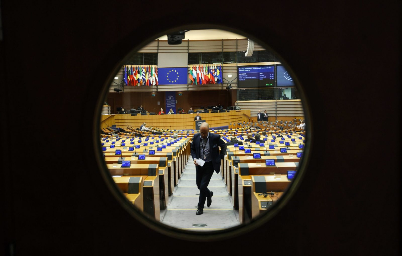 epaselect epa10666398 A view through a bulleye window of the plenary hall's doors during a debate on 'Foreign interference in democratic processes and election integrity' during a mini plenary session of the European Parliament in Brussels, Belgium, 01 June 2023.  EPA/OLIVIER HOSLET