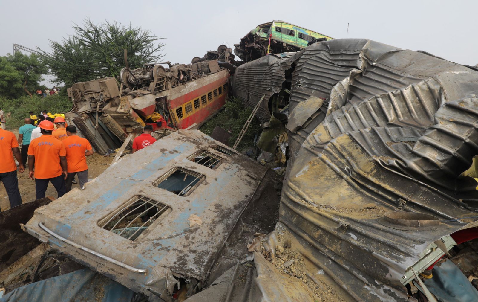 epa10669871 Damaged train coaches are piled up as the National Disaster Response Force Rescue continues work at the site of a train accident at Odisha Balasore, India, 03 June 2023. Over 200 people died and more than 900 were injured after three trains collided one after another. According to railway officials the Coromandel Express, which operates between Kolkata and Chennai, crashed into the Howrah Superfast Express.  EPA/PIYAL ADHIKARY