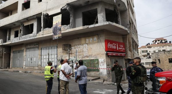 epa10679079 Palestinian security and civil defense members inspect the destroyed house of Palestinian prisoner Islam Froukh, that was demolished by the Israeli forces early morning in the West Bank city of Ramallah, 08 June 2023. Israeli forces during an overnight raid in Ramallah demolished the residence of a suspect in a bomb attack in Jerusalem on 23 November 2022.  EPA/ATEF SAFADI
