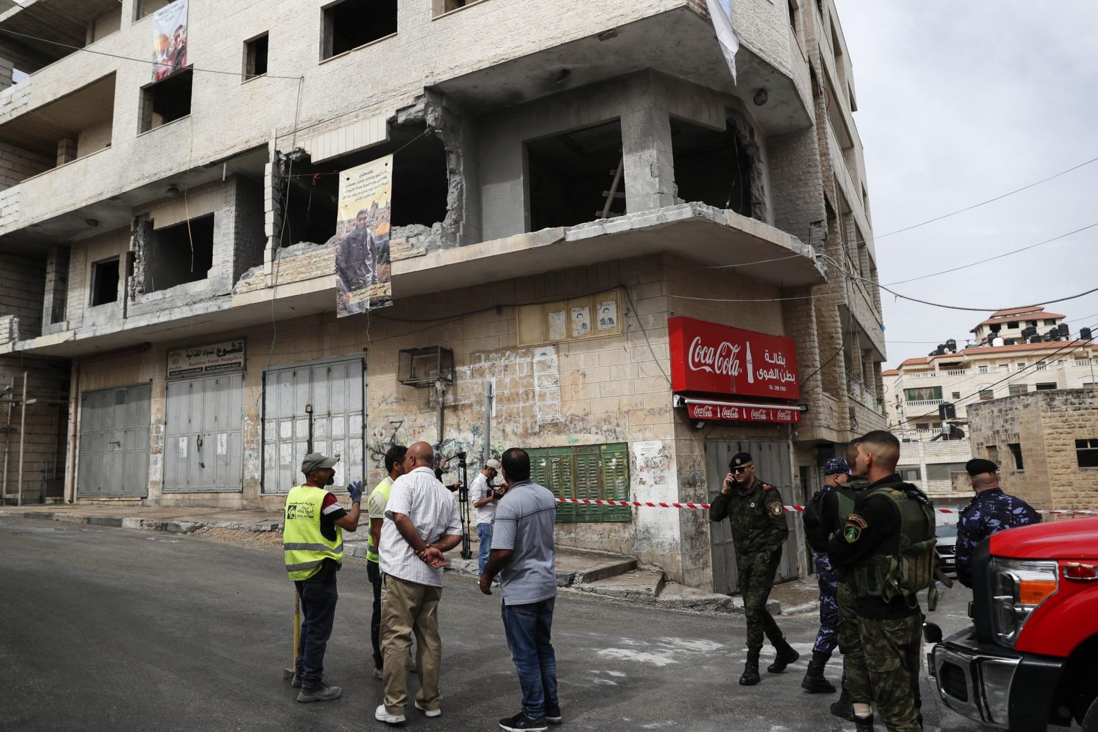 epa10679079 Palestinian security and civil defense members inspect the destroyed house of Palestinian prisoner Islam Froukh, that was demolished by the Israeli forces early morning in the West Bank city of Ramallah, 08 June 2023. Israeli forces during an overnight raid in Ramallah demolished the residence of a suspect in a bomb attack in Jerusalem on 23 November 2022.  EPA/ATEF SAFADI