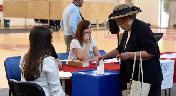 epa10685342 A woman casts her ballot during the Parliamentary elections in Podgorica, Montenegro, 11 June 2023. Montenegro votes in a snap parliamentary election which is seen as an assessment of whether the small Balkan country, that is a member of the NATO, can overcome deep internal political divisions that have been slowing down its European Union membership path.  EPA/BORIS PEJOVIC