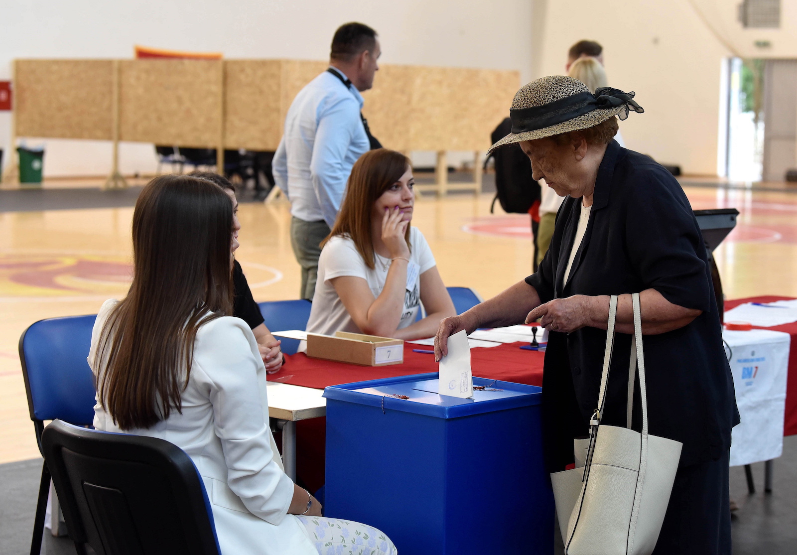 epa10685342 A woman casts her ballot during the Parliamentary elections in Podgorica, Montenegro, 11 June 2023. Montenegro votes in a snap parliamentary election which is seen as an assessment of whether the small Balkan country, that is a member of the NATO, can overcome deep internal political divisions that have been slowing down its European Union membership path.  EPA/BORIS PEJOVIC
