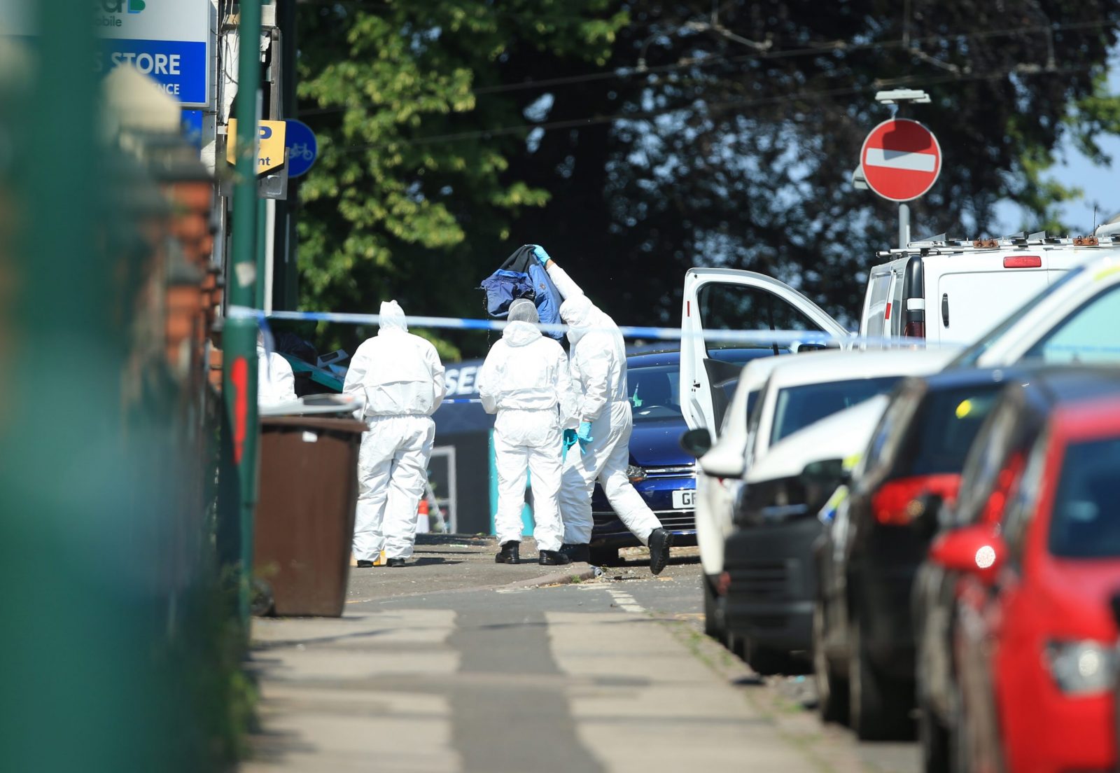 epa10688668 Police forensic officers remove an item from a van that was found on Bentinck Road in Nottingham, Britain, 13 June 2023. Three people were found dead following what police describe as an 'horrific and tragic incident'. A 31-year-old man was arrested on suspicion of murder. Another three people are in hospital after someone tried to run them over in a van. Police believe the incidents are connected.  EPA/LINDSEY PARNABY