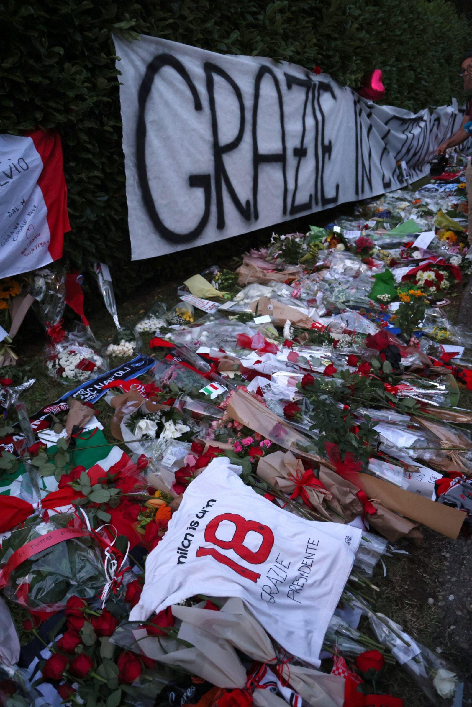 epa10689329 AC Milan supporters pay homage outside Villa San Martino in Arcore, where the coffin of his father, Italy's former prime minister Silvio Berlusconi was brought a day earlier, near Milan, Italy, 13 June 2023. Silvio Berlusconi died at the age of 86 on 12 June 2023 at San Raffaele hospital in Milan, where he was hospitalized again since last 09 June. The Italian media tycoon and Forza Italia (FI) party founder, dubbed as 'Il Cavaliere' (The Knight), served as prime minister of Italy in four governments. The Italian government has declared 14 June 2023 a national day of mourning, when Berlusconi will receive a state funeral in the Milan Cathedral.  EPA/MATTEO BAZZI