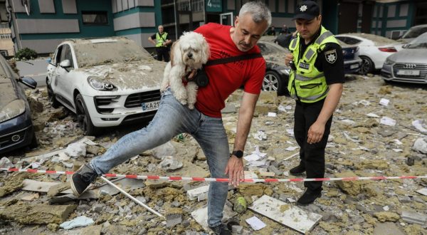 epa10709063 A local resident carries his dog as he leaves the area after an apartment block was damaged by rocket fragments in Kyiv (Kiev), Ukraine, 24 June 2023, amid the Russian invasion. At least three people were killed by rocket fragments hitting a high-rise building in the capital’s Solomyan district, Kyiv Mayor Vitali Klitschko confirmed. According to the Ukrainian Air Force, Russia fired 41 missiles and one shock drone on Ukraine. All air targets were shot down.  EPA/OLEG PETRASYUK