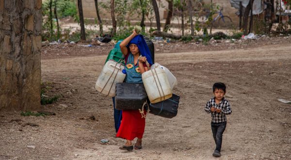 epa10712992 Tzotzil Mayan indigenous people, from the Guadalupe Shu'kun community, fill containers with water in the municipality of Zinacantán, Chiapas, Mexico, 22 June 2023 (Issued 26 June 2023). Hundreds of indigenous Tzotzil Maya are suffering from the drought and the historic heat wave that hit Mexico, as their water sources dry up.  EPA/Carlos López