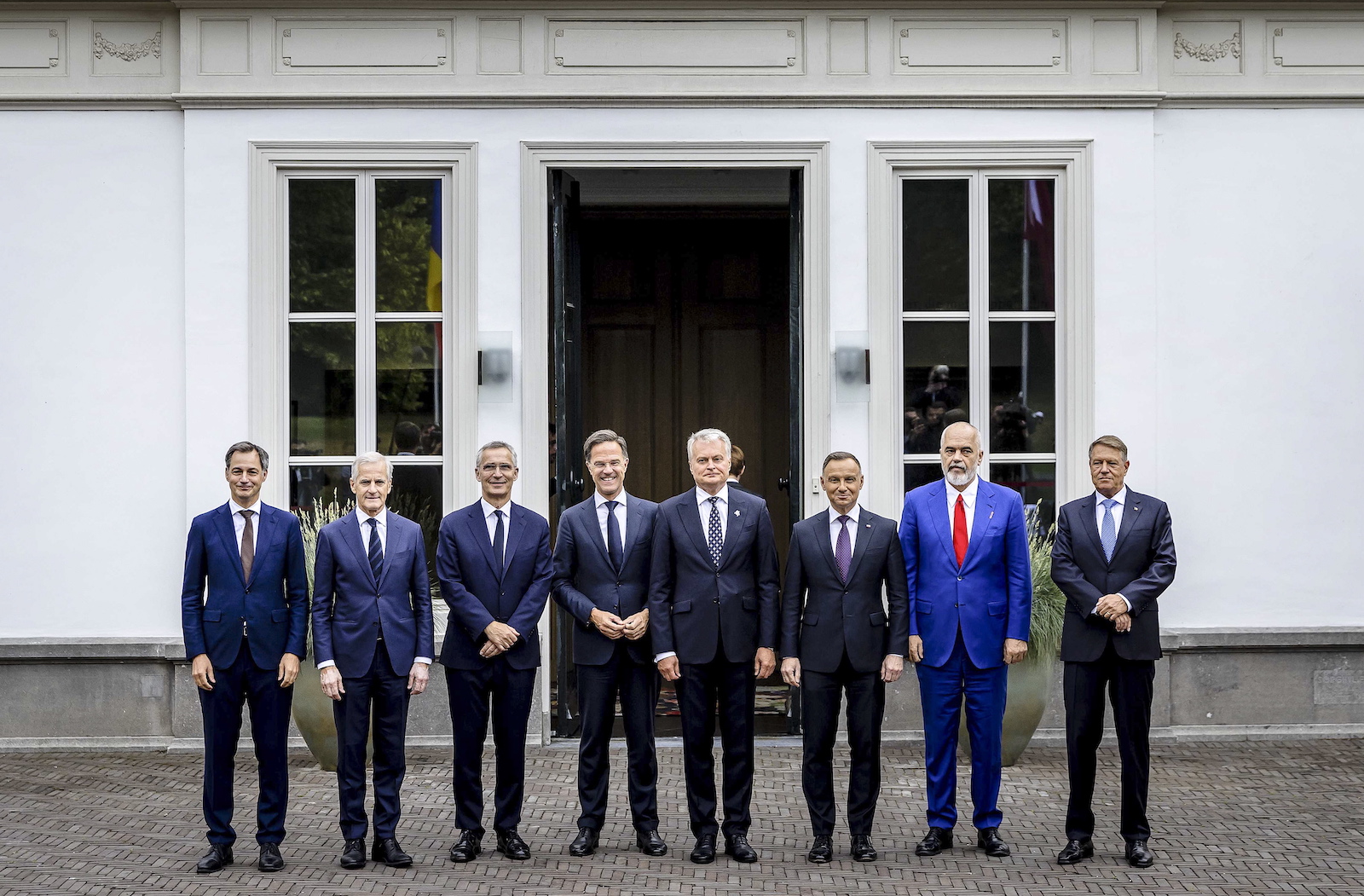 epa10714074 (L-R) Belgian Prime Minister Alexander De Croo, Norwegian Prime Minister Jonas Gahr Store, NATO Secretary General Jens Stoltenberg, Dutch Prime Minister Mark Rutte, Lithuanian President Gitanas Nauseda, Polish President Andrzej Duda, Albanian Prime Minister Edi Rama and Romanian President Klaus Johannis pose for a family photo in front of the Catshuis prior to a meeting in the run-up to the NATO summit to be held in Vilnius, in The Hague, Netherlands, 27 June 2023.  EPA/REMKO DE WAAL