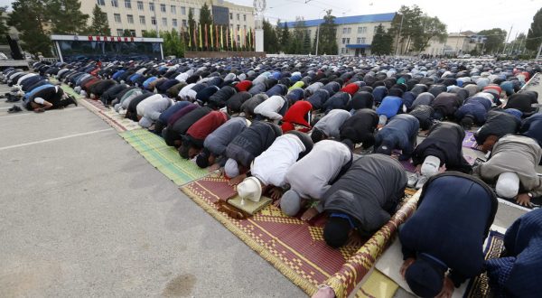 epa10714600 Kyrgyzstanis pray during the celebration of Eid al-Adha in the central square of Naryn, Kyrgyzstan, 28 June 2023. Eid al-Adha is the holiest of the two Muslims holidays celebrated each year, it marks the yearly Muslim pilgrimage (Hajj) to visit Mecca in Saudi Arabia, the holiest place in Islam. Muslims slaughter a sacrificial animal in memory of a biblical story about prophet Abraham readiness to sacrifice his own son after a command from god in a dream. After an animal has been sacrificed the meat is usually split into three parts, one for the family, one for friends and relatives, and one for the poor and needy.  EPA/IGOR KOVALENKO