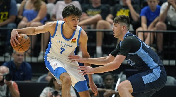 Memphis Grizzlies forward Matthew Hurt, right, guards Oklahoma City Thunder forward Chet Holmgren (7) during the first half during an NBA summer league basketball game Wednesday, July 5, 2023, in Salt Lake City. (AP Photo/Rick Bowmer)