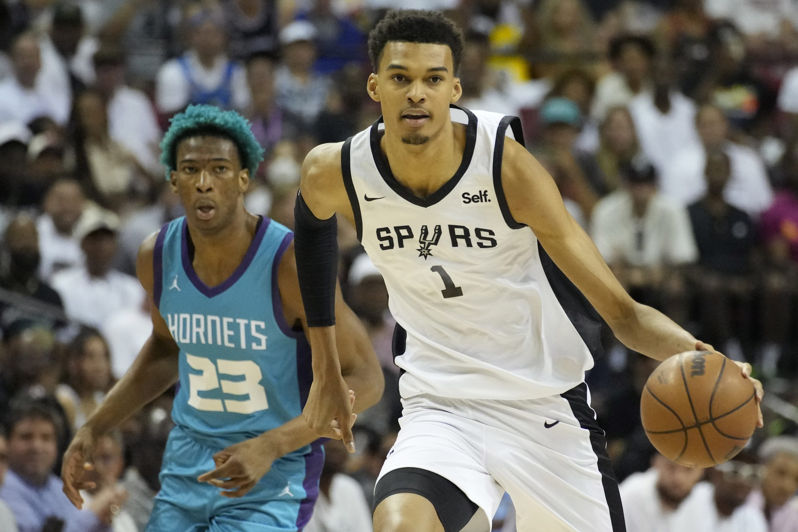 San Antonio Spurs' Victor Wembanyama drives against the Charlotte Hornets during the first half of an NBA summer league basketball game Friday, July 7, 2023, in Las Vegas. (AP Photo/John Locher)