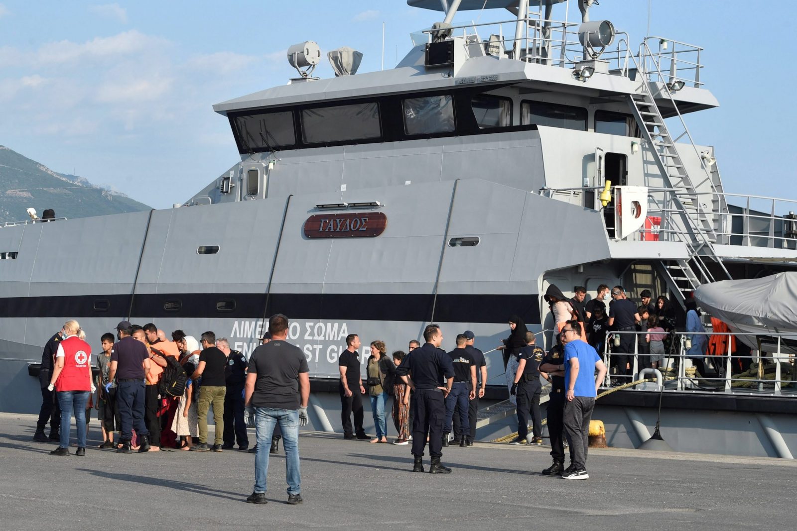 epa10704616 Migrants disembark a Coast Guard vessel as they arrive to port in Kalamata, Peloponnese, Greece, 21 June 2023. The vessel transported 63 migrants, who were found on a sailboat 27 nautical miles southwest of Tainaros, Greece. The rescued people, who say they are mainly citizens of Iraq, Iran, Syria and Morocco, have been transferred to the warehouses where they will remain until the migration proceedings are completed.  EPA/NIKITAS KOTSIARIS