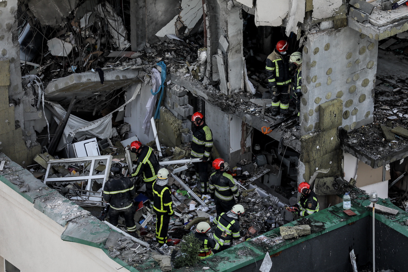 epa10709066 Rescue workers in action after an apartment block was damaged by rocket fragments in Kyiv (Kiev), Ukraine, 24 June 2023, amid the Russian invasion. At least three people were killed by rocket fragments hitting a high-rise building in the capitalâ€™s Solomyan district, Kyiv Mayor Vitali Klitschko confirmed. According to the Ukrainian Air Force, Russia fired 41 missiles and one shock drone on Ukraine. All air targets were shot down.  EPA/OLEG PETRASYUK