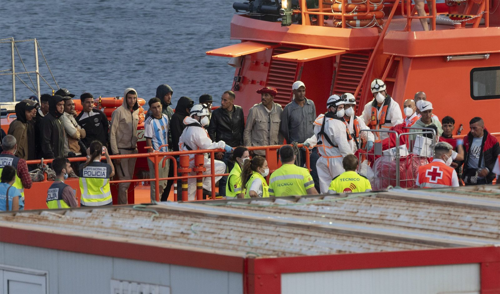 epa10713115 A group of 41 migrants, including a child, reach the port on board a Spanish Sea Rescue Unit's ship in the town of Arrecife, Lanzarote island, southwestern Spain, 26 June 2023 (issued on 27 June 2023). The boat was found 36 km off island's coast.  EPA/Adriel Perdomo