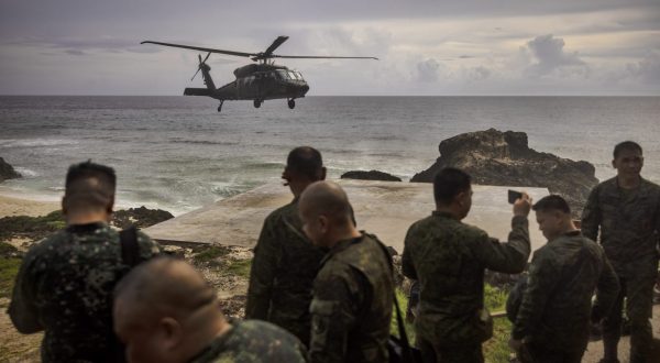 epa10719162 A Philippine Air Force Black Hawk helicopter lands in Mavulis Island, Batanes, Philippines.30 June 2023. Philippines Armed Forces chief General Andres Centino conducted inspection of troops stationed in Muvalis island which lies at the country's northernmost tip near Taiwan.  EPA/EZRA ACAYAN / POOL *** Local Caption *** BATANES, PHILIPPINES - JUNE 29: General Andres Centino, Chief of Staff of the Armed Forces of the Philippines, (3rd from left) takes part in a flag raising ceremony on June 29, 2023 in Mavulis Island, Batanes, Philippines. Amid increasing geopolitical tension between the US, China, and Taiwan, the Philippines is grappling with the potential fallout. Batanes, a group of idyllic islands at the country‚Äôs northernmost tip, lies just 140 kilometers from Taiwan, and its proximity could thrust it into the spotlight in case of conflict. Consequently, local officials and citizens are developing contingency plans to address security, food sufficiency, healthcare provisions, and the potential handling of refugees. (Photo by Ezra Acayan/Getty Images)