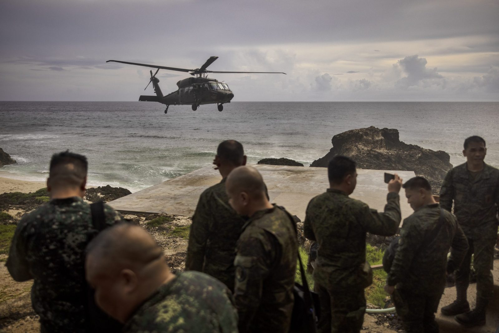 epa10719162 A Philippine Air Force Black Hawk helicopter lands in Mavulis Island, Batanes, Philippines.30 June 2023. Philippines Armed Forces chief General Andres Centino conducted inspection of troops stationed in Muvalis island which lies at the country's northernmost tip near Taiwan.  EPA/EZRA ACAYAN / POOL *** Local Caption *** BATANES, PHILIPPINES - JUNE 29: General Andres Centino, Chief of Staff of the Armed Forces of the Philippines, (3rd from left) takes part in a flag raising ceremony on June 29, 2023 in Mavulis Island, Batanes, Philippines. Amid increasing geopolitical tension between the US, China, and Taiwan, the Philippines is grappling with the potential fallout. Batanes, a group of idyllic islands at the country‚Äôs northernmost tip, lies just 140 kilometers from Taiwan, and its proximity could thrust it into the spotlight in case of conflict. Consequently, local officials and citizens are developing contingency plans to address security, food sufficiency, healthcare provisions, and the potential handling of refugees. (Photo by Ezra Acayan/Getty Images)