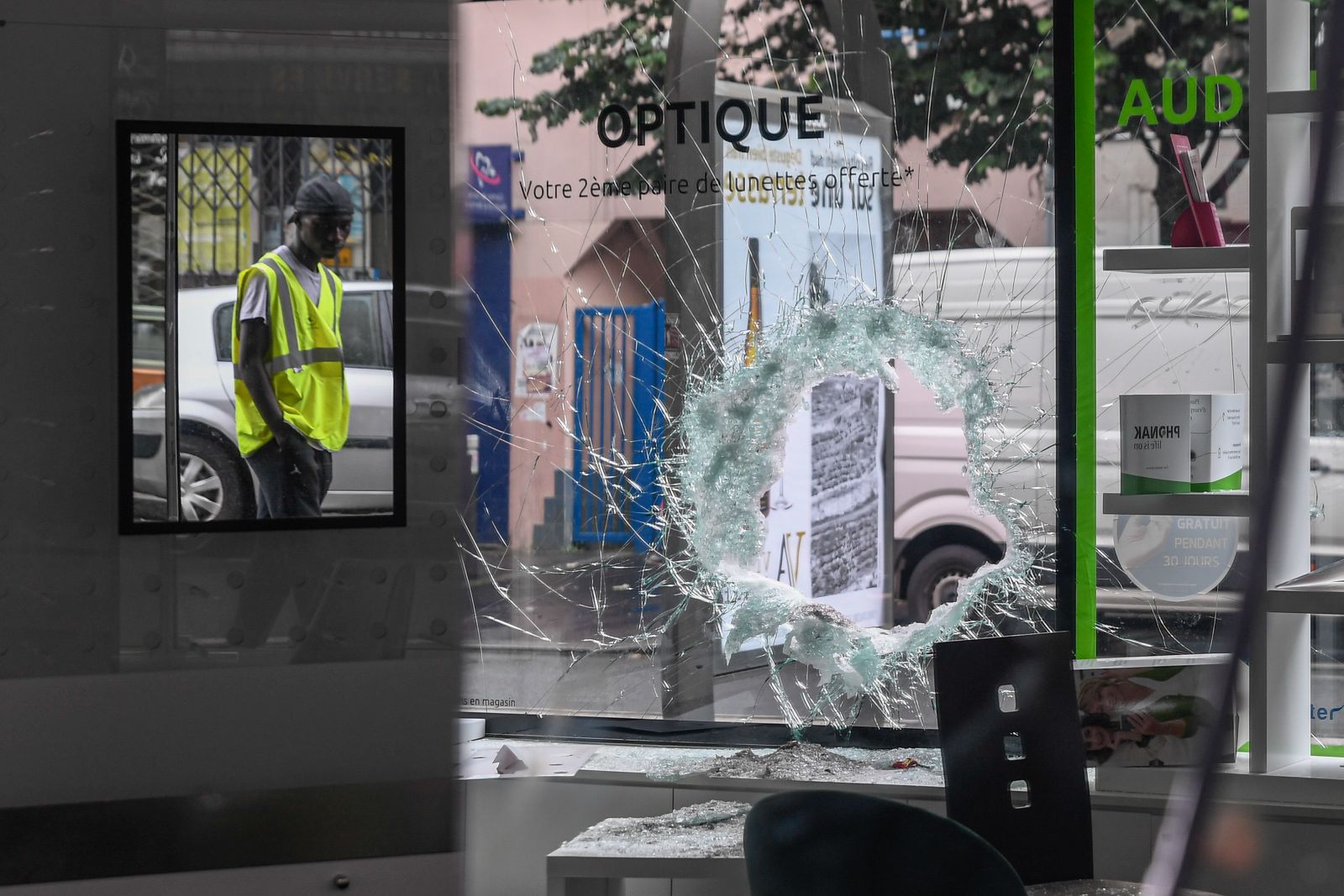 epa10720395 A person inspects a damaged establishment following a night of looting and rioting in Montreuil, near Paris, France, 01 July 2023. Violence broke out across France over the fatal shooting of a 17-year-old teenager by a police officer during a traffic stop in Nanterre on 27 June.  EPA/JULIEN MATTIA
