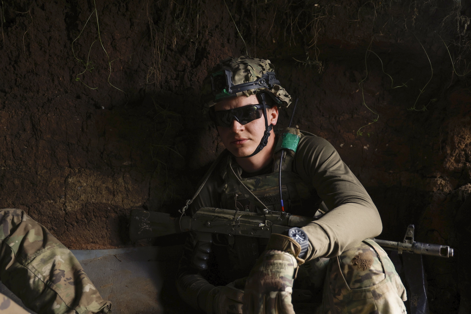 epa10722112 A Ukrainian serviceman nicknamed 'Tikhiy', a member of the 3rd Separate Assault Brigade, takes cover in a trench less than a kilometer away from the active frontline near Bakhmut, Donetsk region, eastern Ukraine, 01 July 2023 (issued 02 July 2023), amid the Russian invasion. The frontline city of Bakhmut, a key target for Russian forces, has seen heavy fighting for months. Russian troops entered Ukrainian territory in February 2022, starting a conflict that has provoked destruction and a humanitarian crisis.  EPA/ALEX BABENKO
