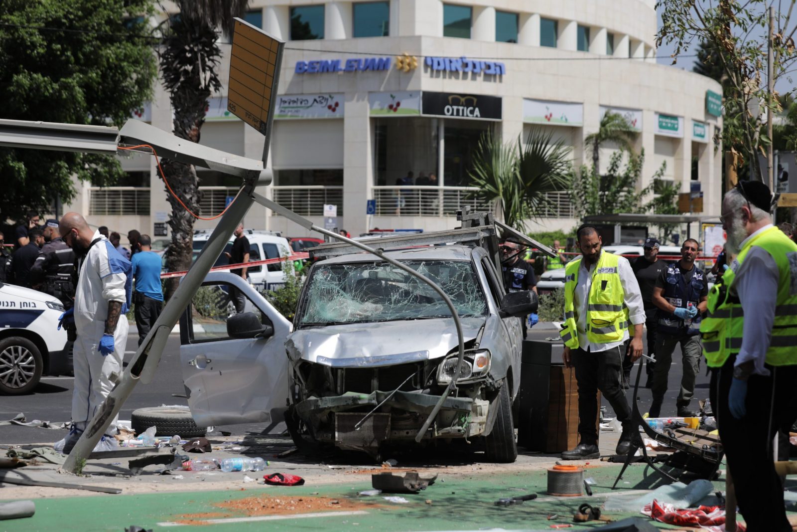 epa10725869 Israeli security forces and emergency workers operate at the site of a car ramming attack in Tel Aviv, Israel, 04 July 2023. According to the Israeli Police on 04 July, about 7 people were injured after a "suspect that was driving a vehicle on Pinchas Rosen street, rammed into pedestrians standing in the shopping center and proceeded to get out of the vehicle to stab civilians with a sharp object". The man involved in the reported event was "neutralized".  EPA/ABIR SULTAN