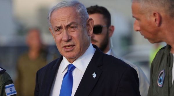 epa10728113 Israeli Prime Minister Benjamin Netanyahu speaks with air force officers during a visit in Palmachim air force base in Rishon Lezion, Israel, 05 July 2023. Netanyahu inspected the air force's array of unmanned aerial vehicles and drones.  EPA/ABIR SULTAN