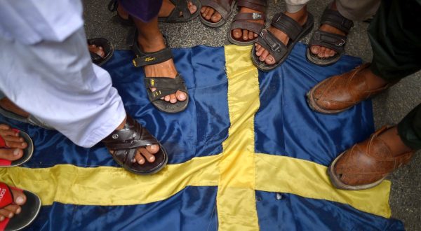 epa10732665 Demonstrators step on a mock Swedish flag during a protest against the burning of a copy of the Muslim holy book in Sweden, in Karachi, Pakistan, 07 July 2023. Pakistan's prime minister called for nationwide protests on 07 July against a recent desecration of the Koran, the holy book of Islam, in Sweden. An Iraqi refugee living in Sweden set fire to a copy of the Koran during a protest in front of a mosque in Stockholm on 28 June 2023. The act drew widespread outrage and condemnation from several countries, including Pakistan, Turkey, Saudi Arabia, Jordan, Palestine, Morocco, Iran, Iraq, and the European Union.  EPA/SHAHZAIB AKBER
