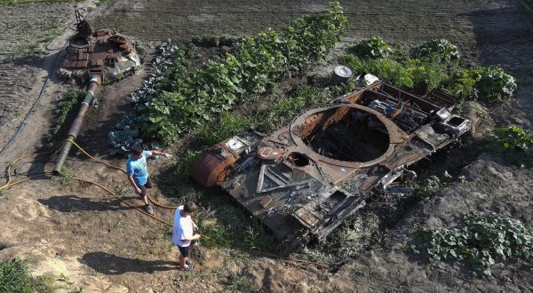 epa10734043 An aerial photo taken with a drone shows local men looking at the remains of a Russian tank in the middle of a garden at the village of Velyka Dymerka, Kyiv region, Ukraine, 05 July 2023 (issued 08 July 2023). Valeriy and Yulia Semynog, together with their three children, left their home when Russian troops arrived at Velyka Dymerka in March 2022. The family returned to their village only after Russian troops were pushed out from the Kyiv region in April 2022. They found their home destroyed along with the wreckage of a Russian tank in the garden. The locals planted flowers and vegetables between and around the wreckage of the tank. Velyka Dymerka as well as other towns and villages in the northern part of the Kyiv region, had become battlefields, heavily shelled, causing death and damage when Russian troops tried to reach the Ukrainian capital of Kyiv in February and March 2022.The war in Ukraine, marks on 08 July its 500th day.  According to the UN more than 9000 civilians have been killed since the war started.  EPA/SERGEY DOLZHENKO