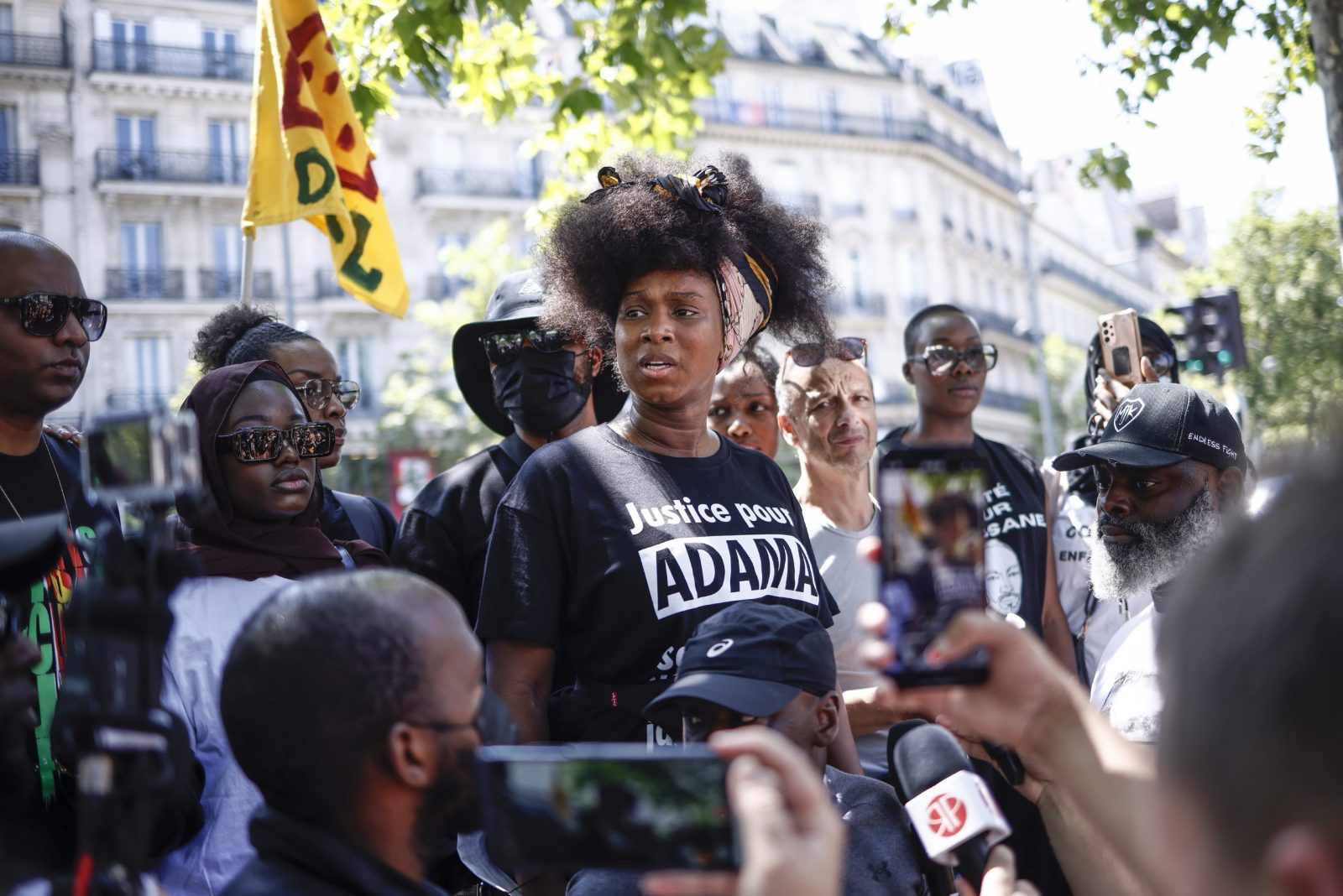 epa10734382 Assa Traore (C), half-sister of Adama Traore delivers a speech during a demonstration against police brutality and racism in Paris, France, 08 July 2023. The protest is organized by supporters of Assa Traore's brother Adama Traore, who died in police custody in 2016, in circumstances that remain unclear.  EPA/YOAN VALAT