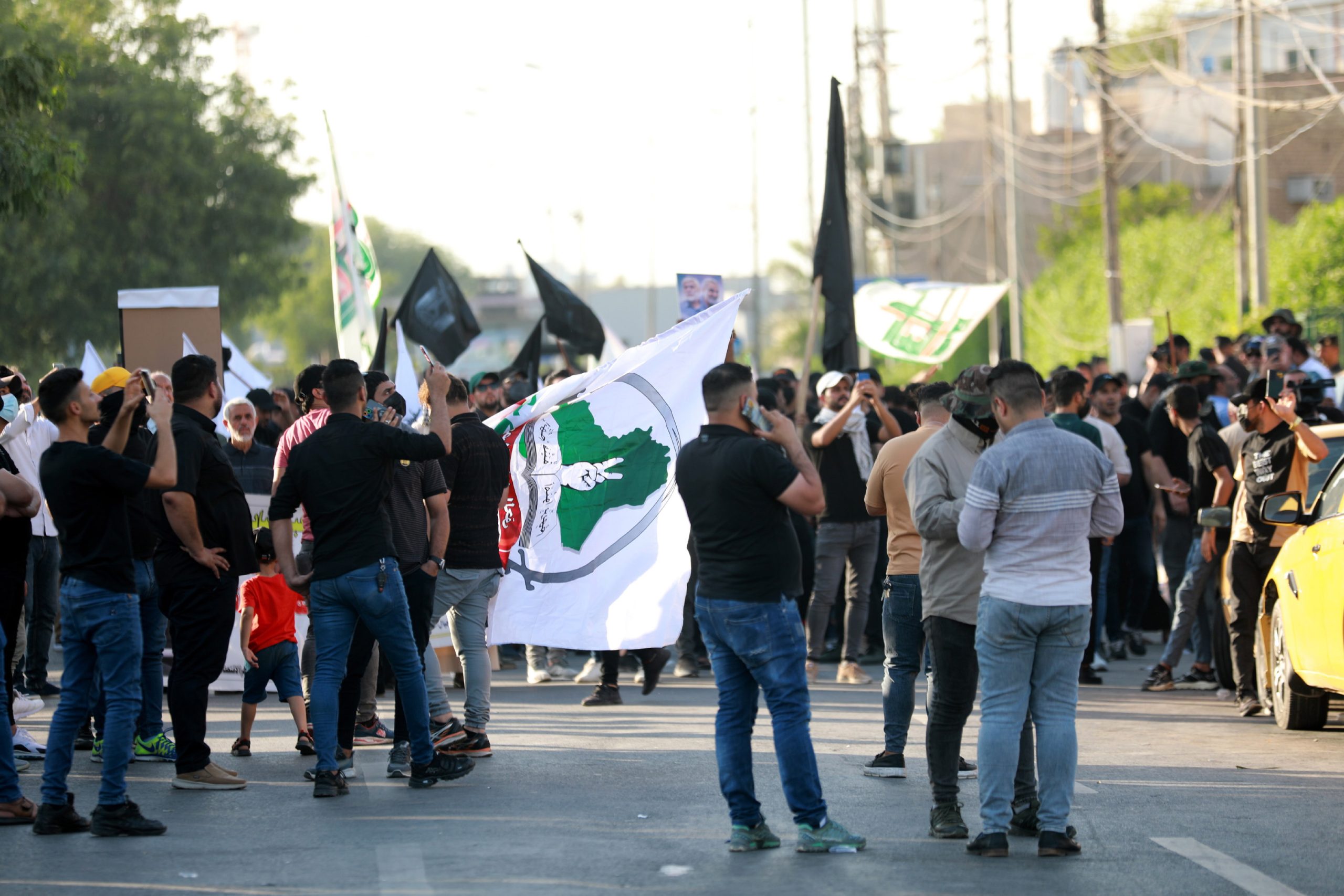 epa10746469 Supporters of Iran-backed Iraqi Shiite armed groups gather during a demonstration near the gate of the Green zone in central Baghdad, Iraq, 14 July 2023. Dozens of Supporters of Iraqi Shiite armed groups demonstrated in central Baghdad to denounce the USA influence in Iraq, while the Iraqi security forces imposed tight security measures around the government area.  EPA/AHMED JALIL