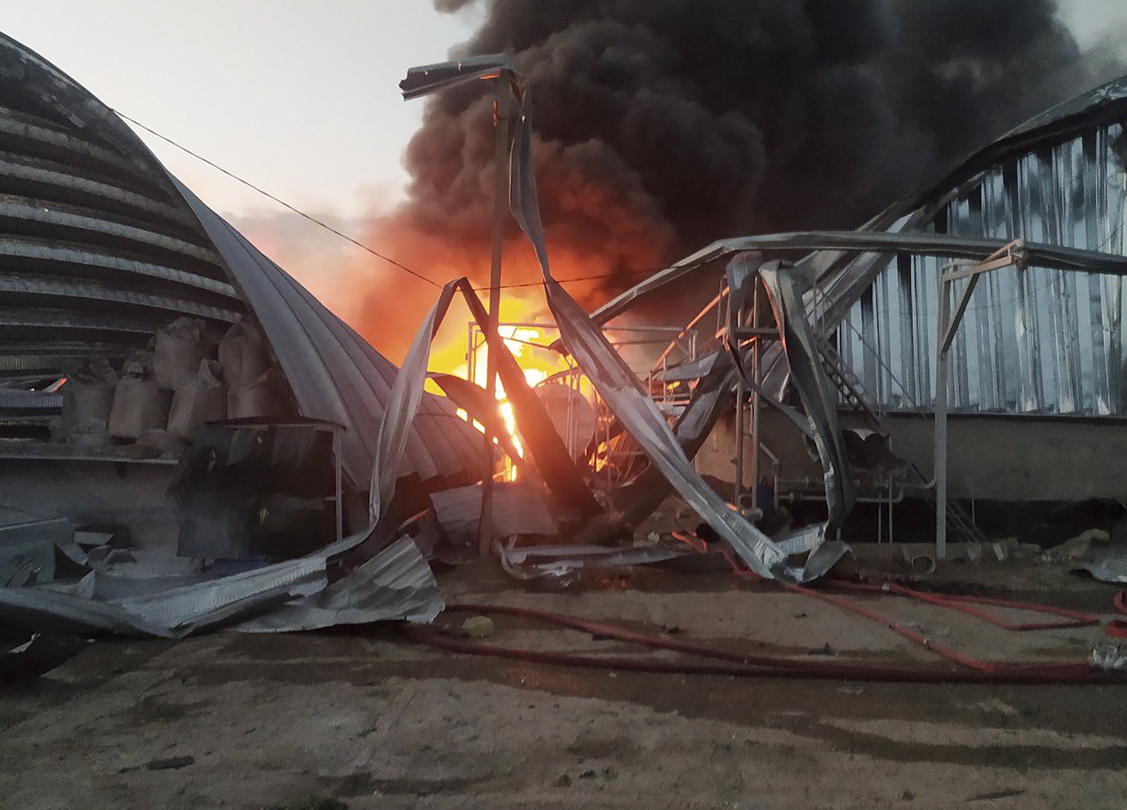 epa10759478 A handout photo made available by the Operational Command South of the Ukrainian Ground Forces shows a damaged grain terminal of an agricultural enterprise in the Odesa region, southern Ukraine, 21 July 2023. About 100 tons of peas and 20 tons of barley were destroyed after Russian forces fired 'Kalibr-type' missiles from the Black Sea targeting the granaries of an agricultural enterprise in the Odesa region, the head of the Odesa Regional Administration, Oleh Kiper said on telegram, adding that at least two people were injured in the attack. Russia, which began its full-scale invasion of Ukraine in February 2022, has recently pulled out of a UN-Turkey brokered agreement guaranteeing safe passage to Ukrainian grain exports through the Black Sea.  EPA/UKRAINE'S OPERATIONAL COMMAND SOUTH HANDOUT -- MANDATORY CREDIT: -- BEST QUALITY AVAILABLE -- HANDOUT EDITORIAL USE ONLY/NO SALES