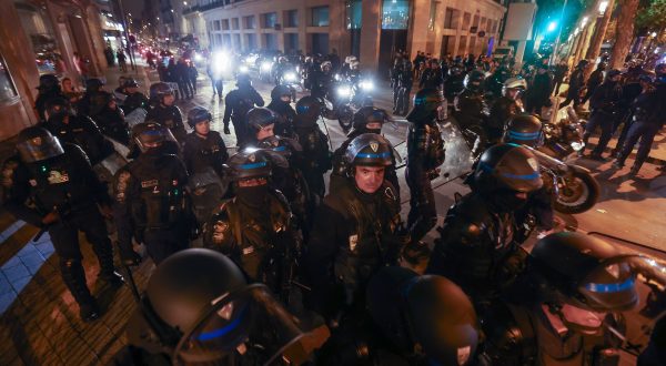 epaselect epa10721741 Riot police forces secure the area near the Arc de triomphe during another night of clashes with protestors in Paris, France, 01 July 2023. Violence broke out all over France after police fatally shot a 17-year-old teenager during a traffic stop in Nanterre on 27 June.  EPA/MOHAMMED BADRA
