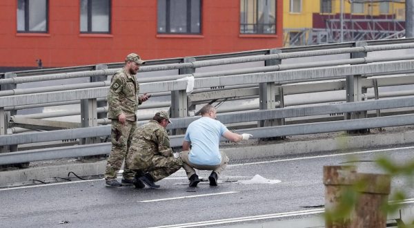 epa10765742 Russian Special Services work outside a damaged building following a drone attack in Moscow, Russia, 24 July 2023. The Russian Ministry of Defense on 24 July accused Ukraine of carrying out an attack with two unmanned aerial vehicles (UAV) against facilities in Moscow, adding that the attack was foiled and the two UAVs 'were suppressed by means of electronic warfare and crashed' leaving no casualties.  EPA/MAXIM SHIPENKOV