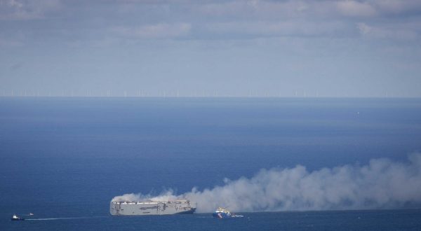 epa10770008 The cargo ship Fremantle Highway is on fire in the North Sea north of Ameland, the Netherlands, 26 July 2023. A fire broke out overnight on 26 July on the Fremantle Highway, a freighter with 23 crew members onboard, in the North Sea, north of Ameland. According to the Dutch Coast Guard, one person died, and several got hurt.  EPA/JAN SPOELSTRA