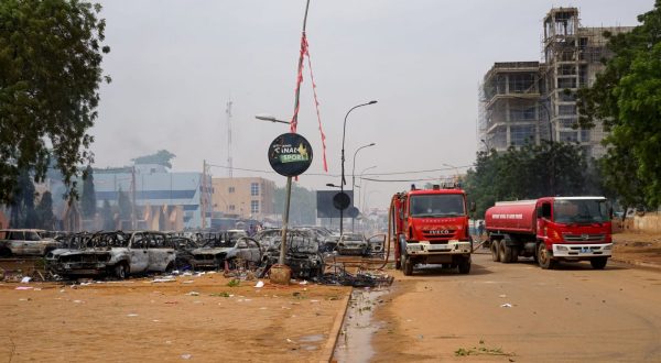 epa10771854 Firefighter trucks next to torched cars at a parking lot near the Nigerien Party for Democracy and Socialism headquarters in Niamey, Niger, 27 July 2023. Mutinous soldiers calling themselves the National Council for the Safeguarding of the Country claimed to have overthrown President Mohamed Bazoum, Niger's democratically elected President, in a Televised address on 26 July evening.  EPA/STR