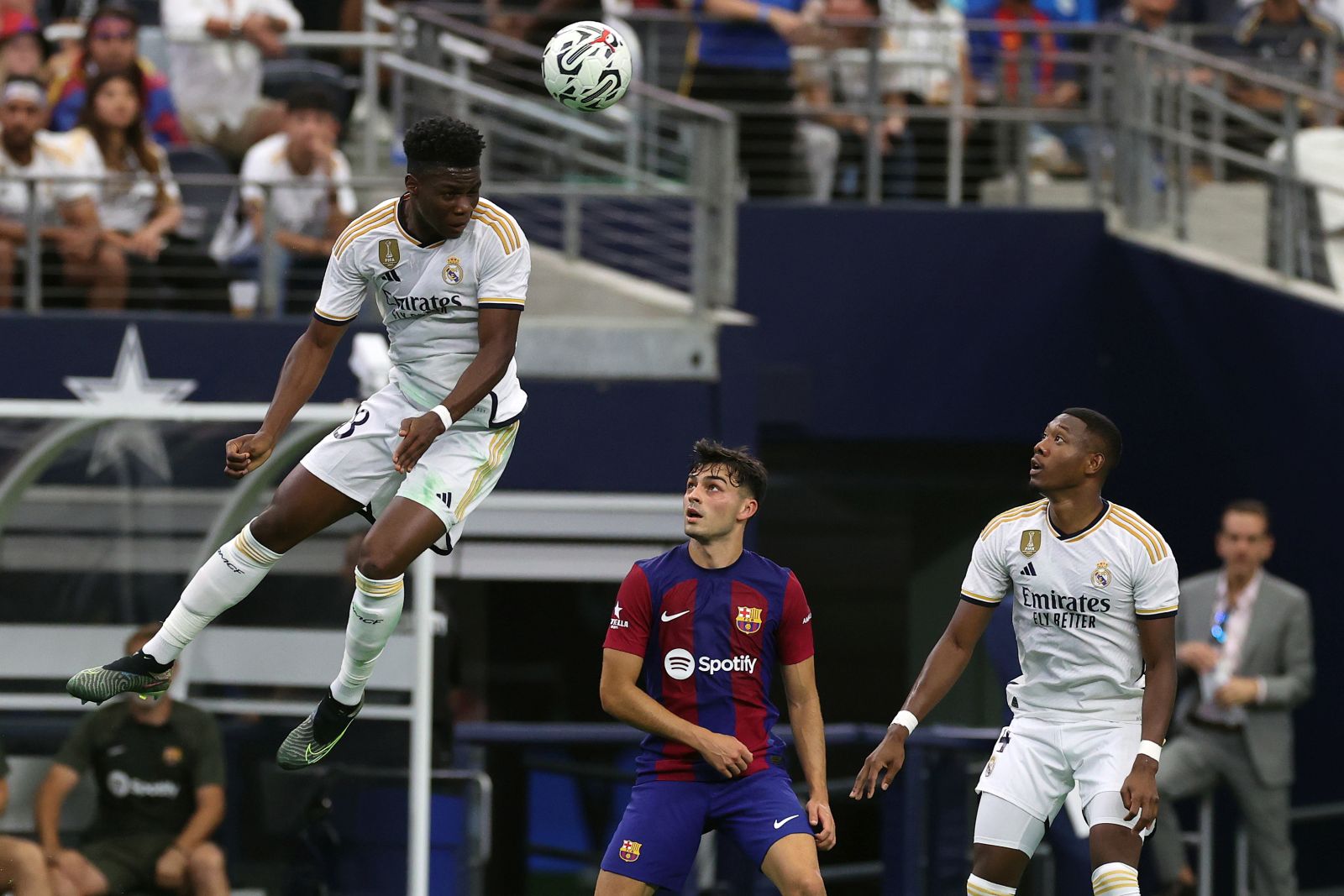 epa10776158 Real Madrid Aurelien Tchouameni (L) in action as his teammate David Alaba (R) and Pedri of Barcelona (C) react during the friendly soccer match between FC Barcelona and Real Madrid, in Arlington, Texas, USA, 29 July 2023.  EPA/ADAM DAVIS