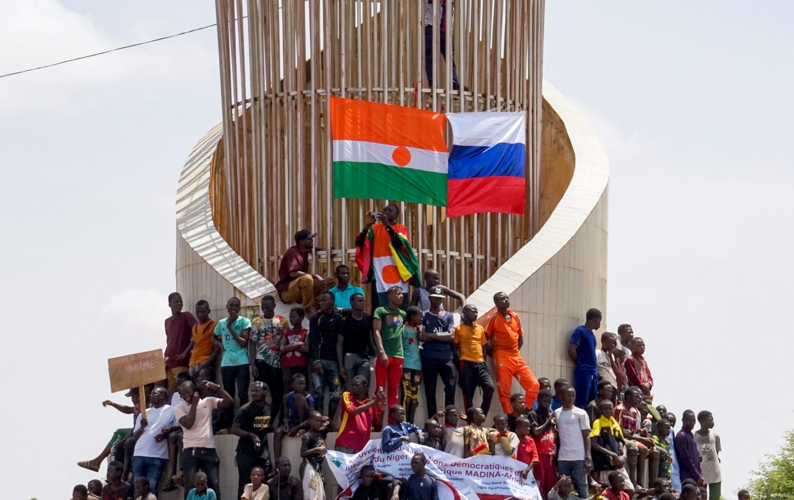 epa10777343 Protesters display the flags of Niger and Russia during a protest in Niamey, Niger, 30 July 2023. Thousands of supporters of General Abdourahamane Tchiani, head of the Presidential Guard, who declared himself the new leader of Niger after a coup against democratically elected President Mohamed Bazoum on 26 July, took to the streets of Niamey to demonstrate support for the coup.  EPA/ISSIFOU DJIBO