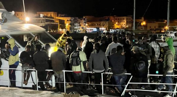 epa10792874 Migrants disembark from a harbor master's patrol boat that arrived at the commercial port of the island of Lampedusa, Italy, 10 August 2023. A group of 340 migrants were rescued at sea and taken to Lampedusa.  EPA/ELIO DESIDERIO